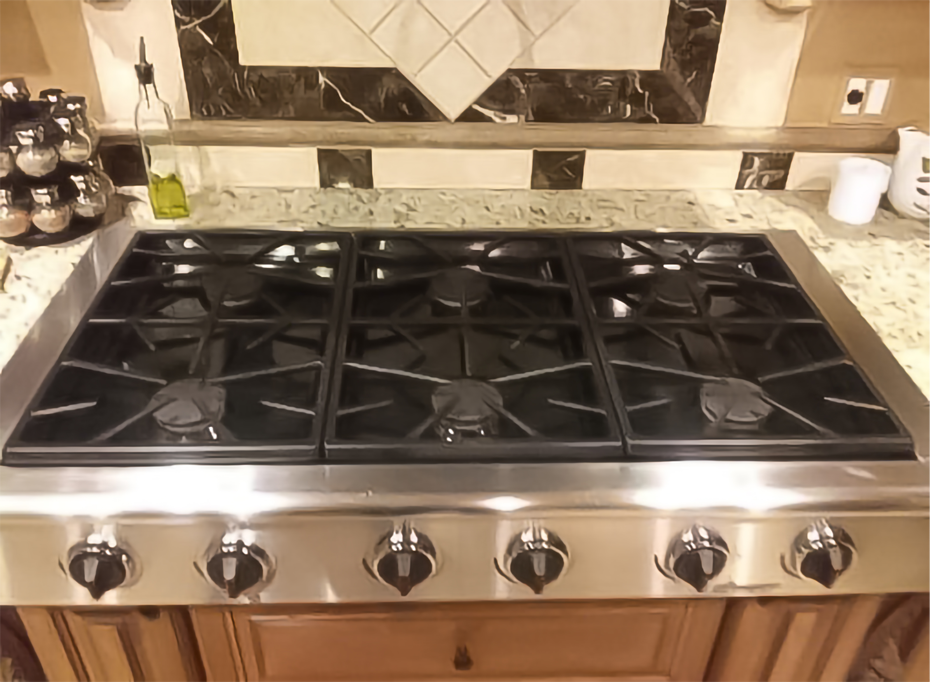 Spotless luxury gas range stove top — vacation rental cleaning